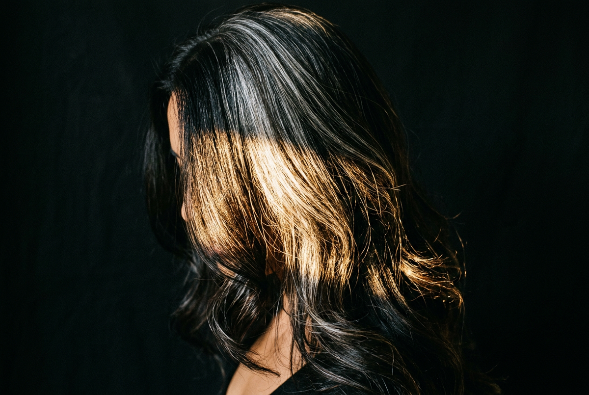 Confident woman with silver-streaked hair representing gray hair myths debunked by science
